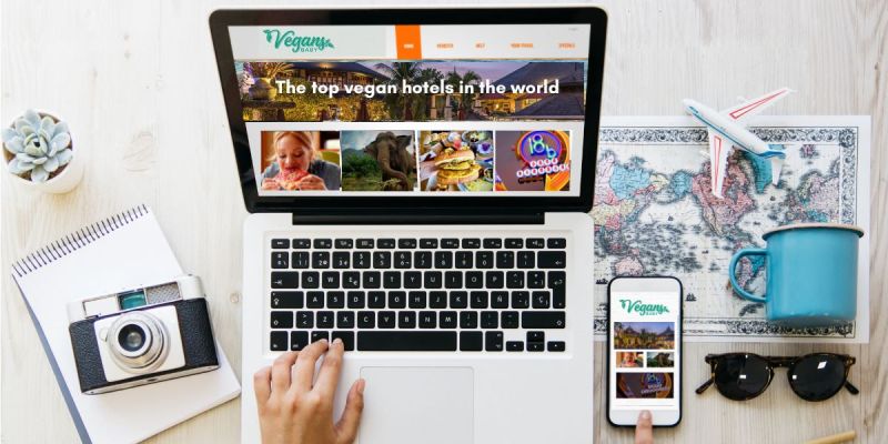Vegan travel planning on a laptop and phone showing Vegans, Baby travel guides