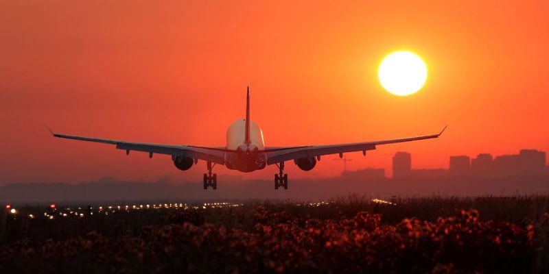 Airplane taking off at sunset symbolizing a well-planned vegan trip