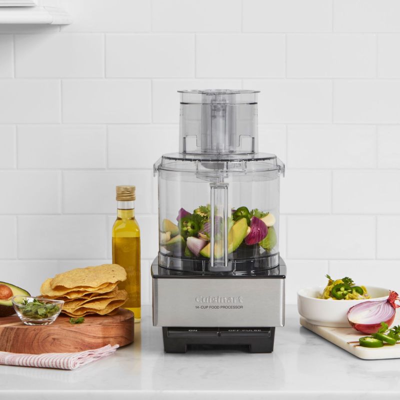 Cuisinart 14-Cup food processer filled with veggies and surrounded by tacos and more veggies
