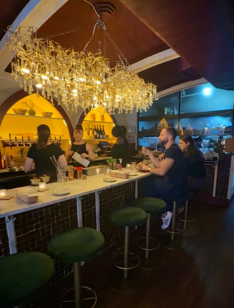 Al-Andalus bar with elegant chandeliers and velvet stools