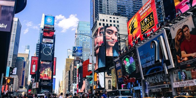 Times Square in Midtown Manhattan with billboards, crowds, and busy city energy