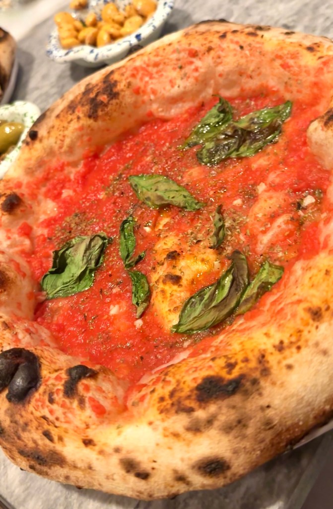 Classic marinara pizza at Una Pizza Napoletana in NYC with tomato, garlic, oregano, basil, and olive oil