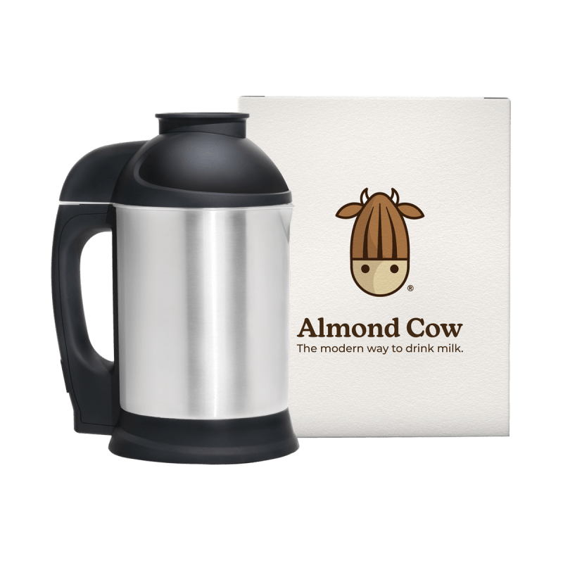 Almond Cow stainless steel milk maker with branded box behind it